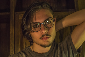 a man with long hair and glasses